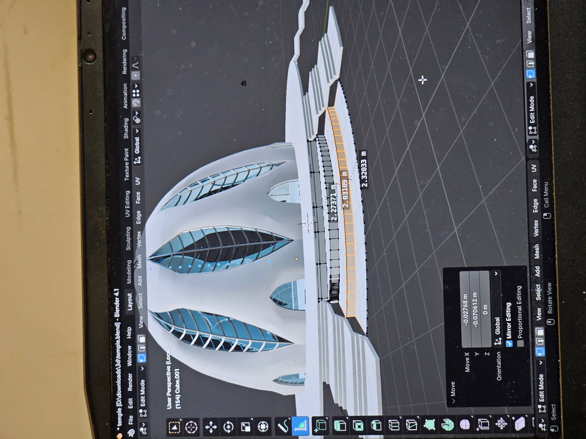 Laptop with a work-in-progress preview of the temple model.